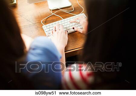 Two teenage girls using computer View Large Photo Image Stock Image - Two teenage girls using computer. Fotosearch