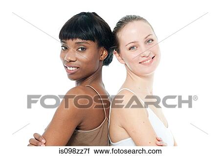 Stock Image - Two young women back to back. Fotosearch