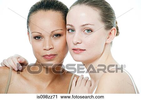 Stock Image - Two young women close together. Fotosearch
