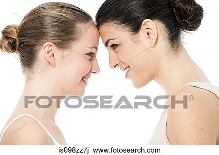 Stock Image - Two young women face to face. Fotosearch