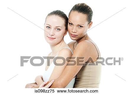 Stock Photography - Two young women hugging. Fotosearch