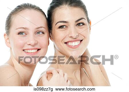 Two young women looking away View Large Photo Image Stock Image - Two young women looking away. Fotosearch