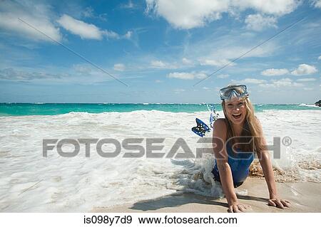 Stock Photo - Woman at water's edge, Mustique, Grenadine Islands. Fotosearch