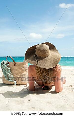Woman lying on sandy beach, Mustique, Grenadine Islands View Large Photo Image Stock Photograph - Woman lying on sandy beach, Mustique, Grenadine Islands. Fotosearch