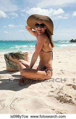 Woman sitting on sandy beach, Mustique, Grenadine Islands View Large Photo Image Stock Photo - Woman sitting on sandy beach, Mustique, Grenadine Islands. Fotosearch
