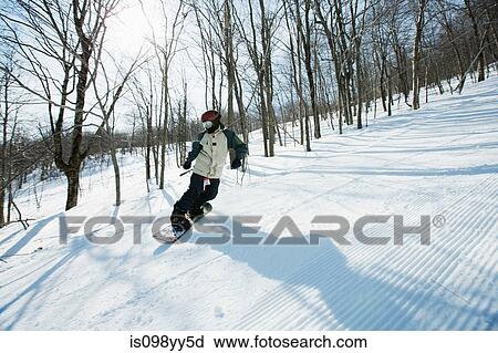 Stock Image - Woman snowboarding. Fotosearch