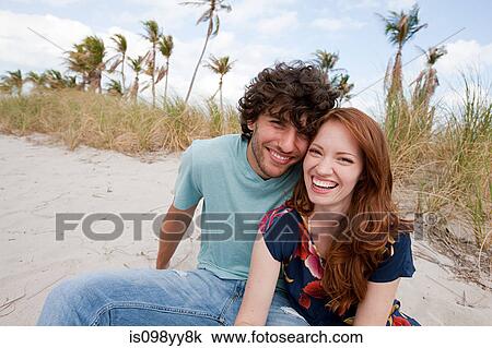 Stock Image - Young couple on beach, portrait. Fotosearch