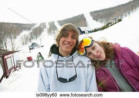Young couple wearing winter sports clothing, portrait View Large Photo Image Stock Image - Young couple wearing winter sports clothing, portrait. Fotosearch