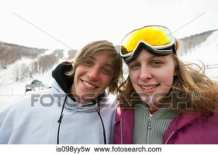Young couple wearing winter sports clothing, portrait View Large Photo Image Stock Photo - Young couple wearing winter sports clothing, portrait. Fotosearch