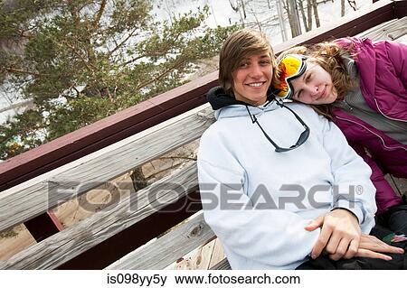 Stock Photo - Young couple wearing winter sports clothing, portrait. Fotosearch