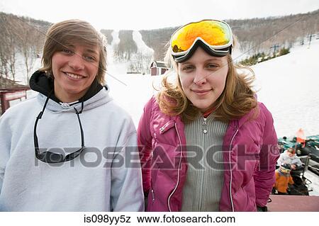 Young couple wearing winter sports clothing, portrait View Large Photo Image Stock Photo - Young couple wearing winter sports clothing, portrait. Fotosearch
