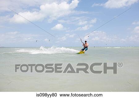 Young man kitesurfing View Large Photo Image Stock Image - Young man kitesurfing. Fotosearch