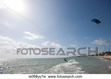 Young man kitesurfing View Large Photo Image Stock Photo - Young man kitesurfing. Fotosearch