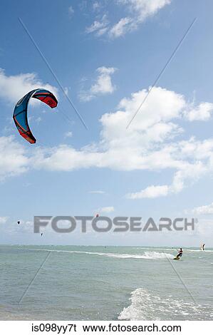 Young man kitesurfing View Large Photo Image Stock Photograph - Young man kitesurfing. Fotosearch