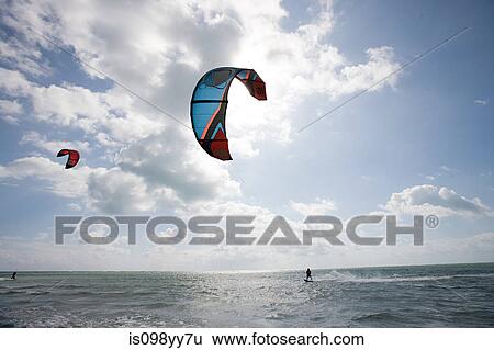Young man kitesurfing View Large Photo Image Stock Photograph - Young man kitesurfing. Fotosearch