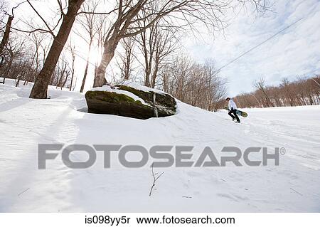 Young man walking uphill with snowboard View Large Photo Image Stock Photography - Young man walking uphill with snowboard. Fotosearch