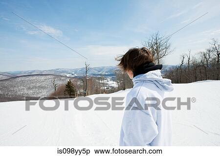 Stock Photography - Young man wearing hooded top looking away. Fotosearch