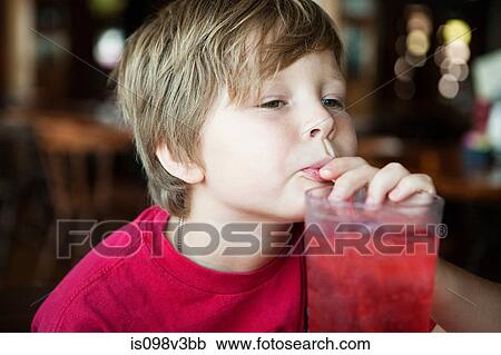 Boy drinking red soft drink View Large Photo Image Stock Image - Boy drinking red soft drink. Fotosearch