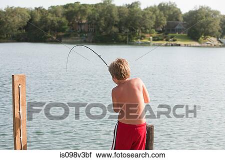 Stock Image - Boy fishing in lake. Fotosearch