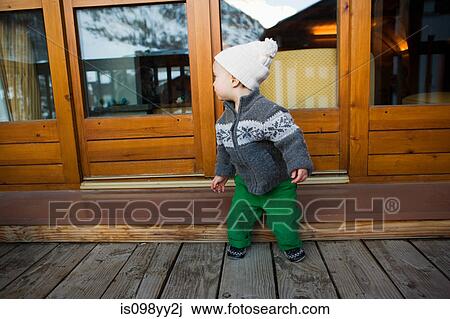 Boy outside wooden chalet View Large Photo Image Stock Image - Boy outside wooden chalet. Fotosearch