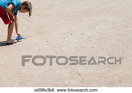 Boy playing with toy airplane on floor View Large Photo Image Stock Photograph - Boy playing with toy airplane on floor. Fotosearch
