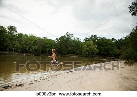 Boy running into lake View Large Photo Image Picture - Boy running into lake. Fotosearch