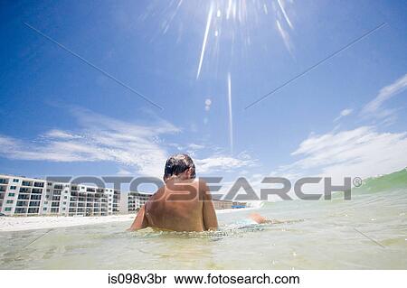 Boy sitting in sea on vacation View Large Photo Image Stock Photography - Boy sitting in sea on vacation. Fotosearch