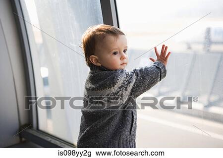 Boy touching airport window View Large Photo Image Stock Image - Boy touching airport window. Fotosearch