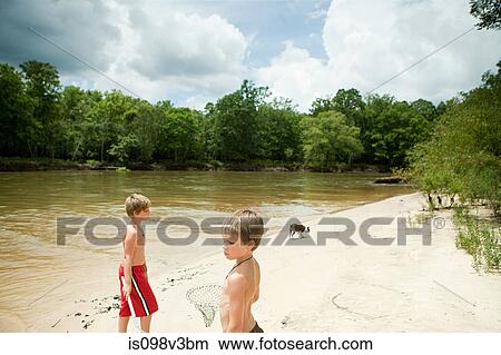 Boys at waters edge View Large Photo Image Picture - Boys at waters edge. Fotosearch