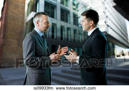 Businessmen having conversation View Large Photo Image Picture - Businessmen having conversation. Fotosearch