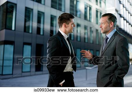 Businessmen having conversation View Large Photo Image Stock Photo - Businessmen having conversation. Fotosearch