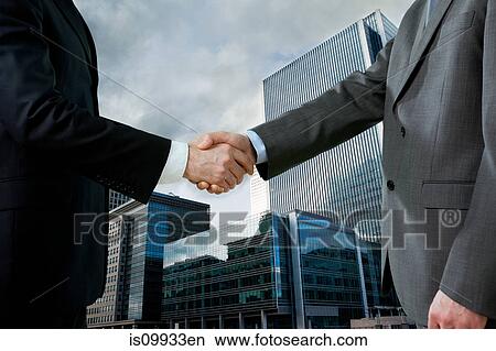 Picture - Businessmen shaking hands. Fotosearch