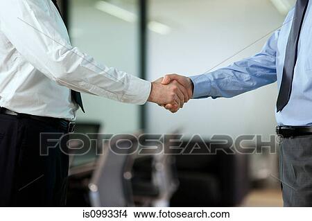Picture - Businessmen shaking hands. Fotosearch