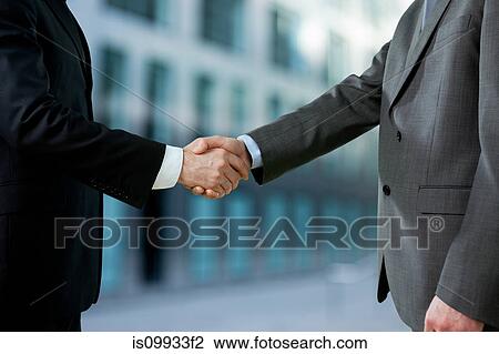 Stock Image - Businessmen shaking hands. Fotosearch