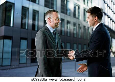 Stock Image - Businessmen shaking hands. Fotosearch
