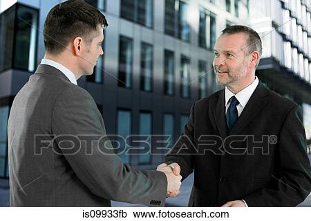 Stock Image - Businessmen shaking hands. Fotosearch