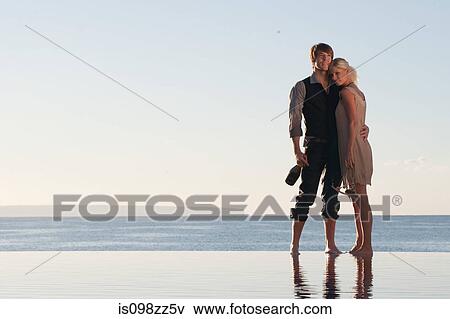 Couple by the ocean View Large Photo Image Stock Photo - Couple by the ocean. Fotosearch