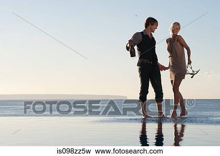 Couple by the ocean View Large Photo Image Stock Photo - Couple by the ocean. Fotosearch