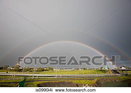 Stock Image - Double rainbow over highway, Co. Galway, Ireland. Fotosearch