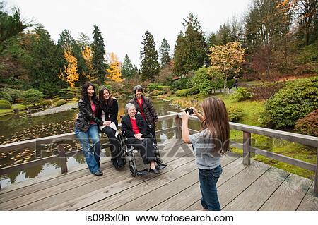 Girl photographing multi generation family View Large Photo Image Picture - Girl photographing multi generation family. Fotosearch