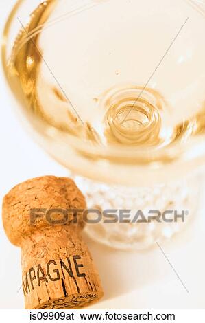 Glass of champagne and cork, close up View Large Photo Image Stock Photograph - Glass of champagne and cork, close up. Fotosearch
