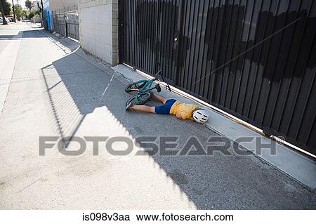 Injured cyclist lying on sidewalk View Large Photo Image Stock Image - Injured cyclist lying on sidewalk. Fotosearch