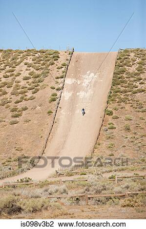 Man riding dirt bike on dirt track View Large Photo Image Stock Image - Man riding dirt bike on dirt track. Fotosearch
