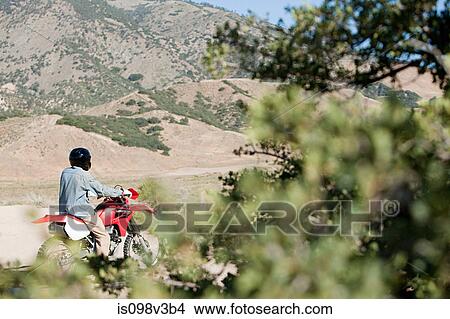 Picture - Man riding dirt bike. Fotosearch