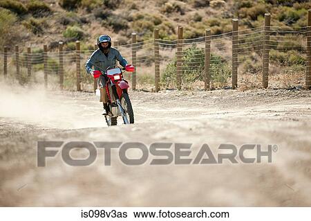 Stock Photograph - Man riding dirt bike. Fotosearch