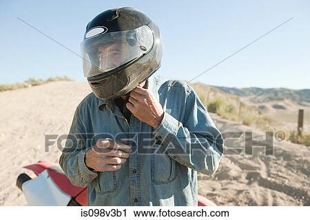 Stock Image - Man wearing crash helmet. Fotosearch