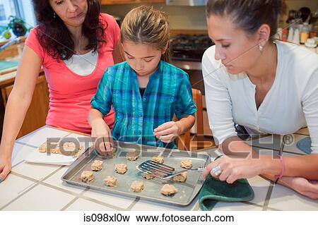 Mother and daughters baking cookies View Large Photo Image Stock Photo - Mother and daughters baking cookies. Fotosearch