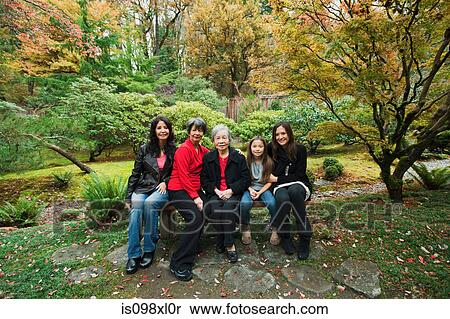Stock Photography - Multi generation family sitting in park. Fotosearch