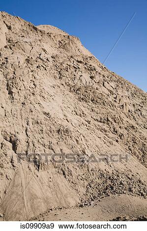 Pile of sand against blue sky View Large Photo Image Stock Photo - Pile of sand against blue sky. Fotosearch