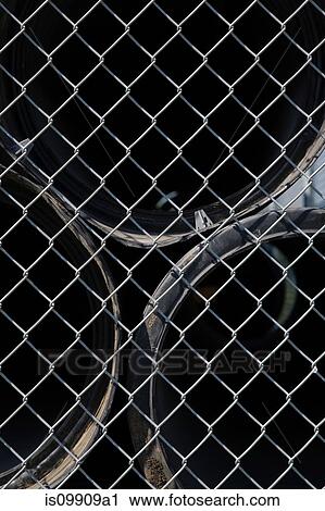 Pipes behind wire mesh fence View Large Photo Image Stock Image - Pipes behind wire mesh fence. Fotosearch